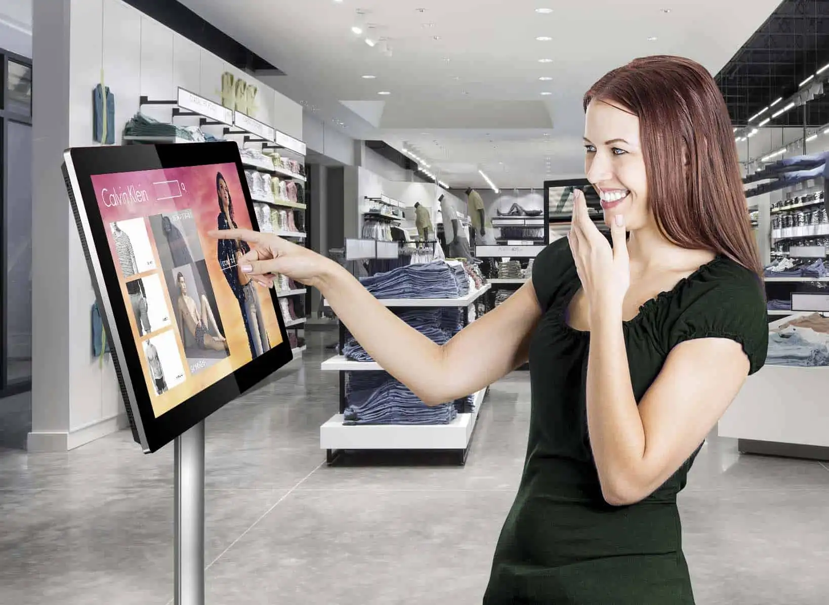 Customer using an interactive touchscreen display inside a fashion retail store to browse products and check inventory